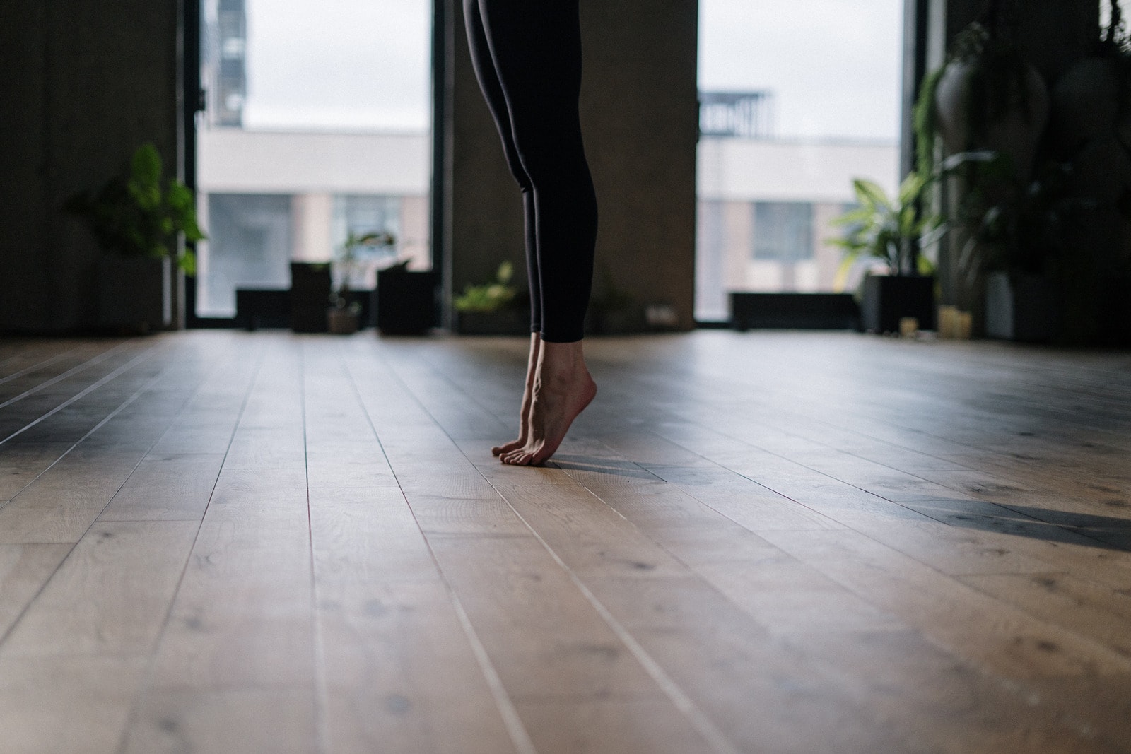 Canva person in black pants and brown shoes standing on gray concrete floor 1