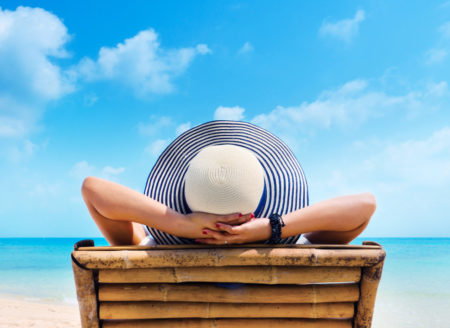 Woman in hat relaxing on beach looking at sea t20 nqd1x7 450x328 1
